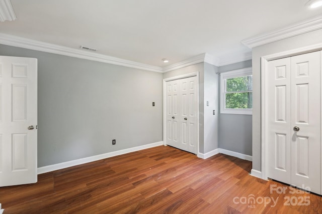 8 Hickory Ridge Ct, Clover, SC 29710 - unfurnished bedroom featuring two closets, wood finished floors, and crown molding