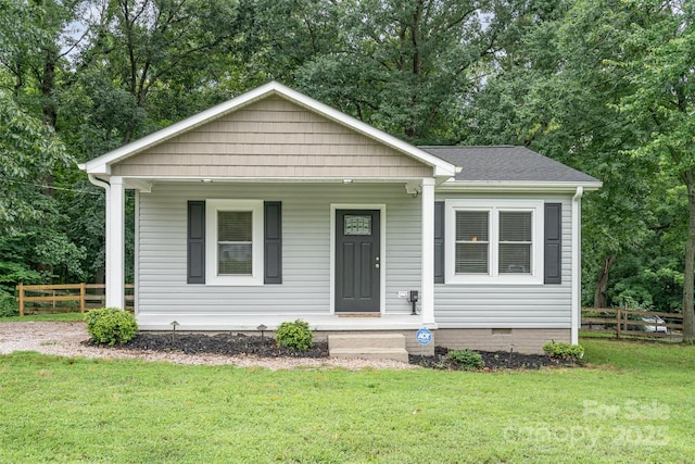 8107 Smith Rd, Kannapolis, NC 28081 - bungalow with covered porch, view of wooded area, and a shingled roof