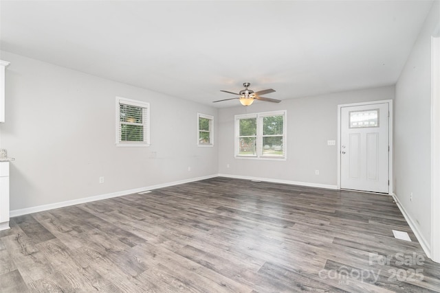 8107 Smith Rd, Kannapolis, NC 28081 - unfurnished living room featuring a ceiling fan and wood finished floors