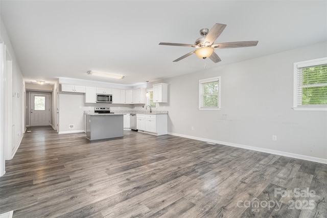 8107 Smith Rd, Kannapolis, NC 28081 - unfurnished living room featuring dark wood-type flooring and ceiling fan