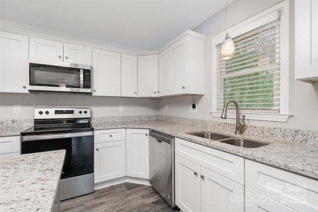 8107 Smith Rd, Kannapolis, NC 28081 - kitchen featuring stainless steel appliances, white cabinetry, dark wood-style floors, hanging light fixtures, and light stone counters