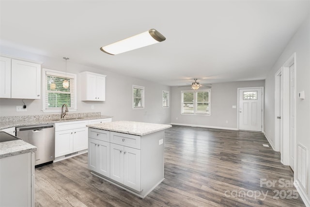 8107 Smith Rd, Kannapolis, NC 28081 - kitchen with stainless steel dishwasher, healthy amount of natural light, a ceiling fan, and white cabinets