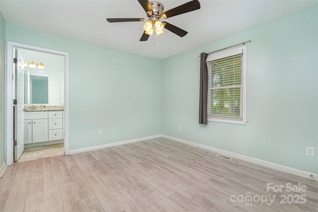 8107 Smith Rd, Kannapolis, NC 28081 - unfurnished bedroom featuring light wood-type flooring, ensuite bath, and ceiling fan
