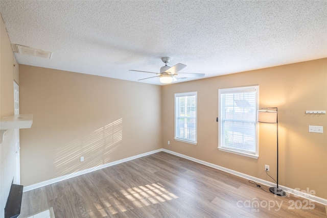 1533 20th Ave NE, Hickory, NC 28601 - empty room with wood finished floors, a ceiling fan, and a textured ceiling