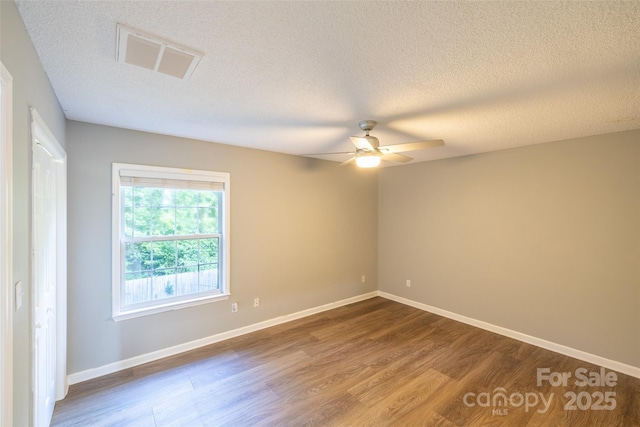 1533 20th Ave NE, Hickory, NC 28601 - empty room featuring dark wood finished floors, ceiling fan, and a textured ceiling