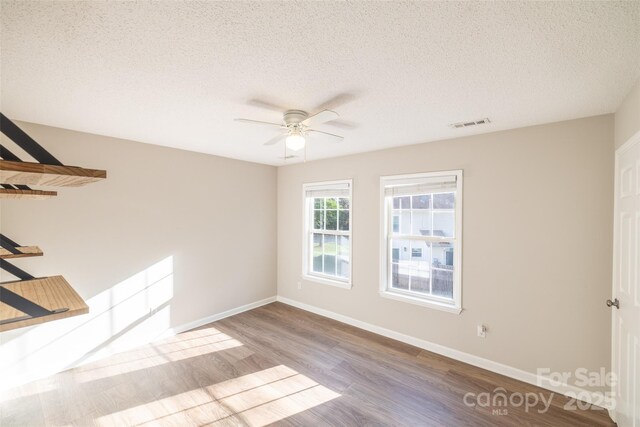 1533 20th Ave NE, Hickory, NC 28601 - empty room with wood finished floors, ceiling fan, and a textured ceiling