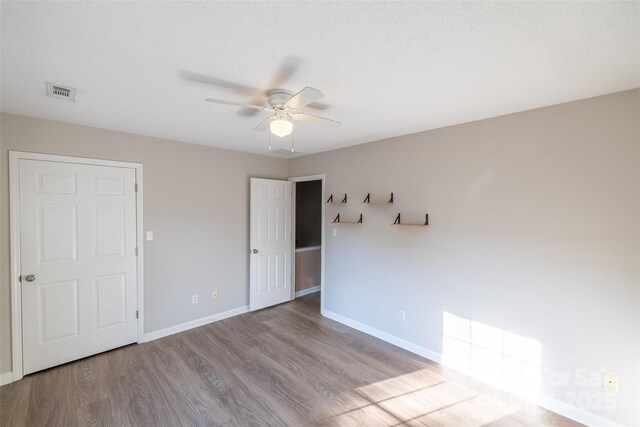 1533 20th Ave NE, Hickory, NC 28601 - unfurnished bedroom with wood finished floors and a ceiling fan