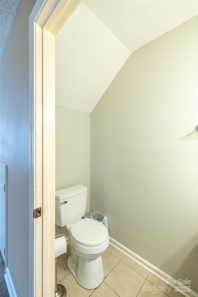 1533 20th Ave NE, Hickory, NC 28601 - bathroom featuring vaulted ceiling, a textured ceiling, and tile patterned flooring