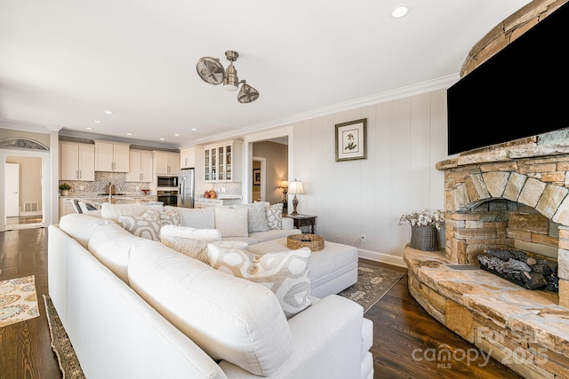 11 By The Wayside Dr, Columbus, NC 28722 - living room featuring dark wood-style floors, ornamental molding, recessed lighting, and a stone fireplace