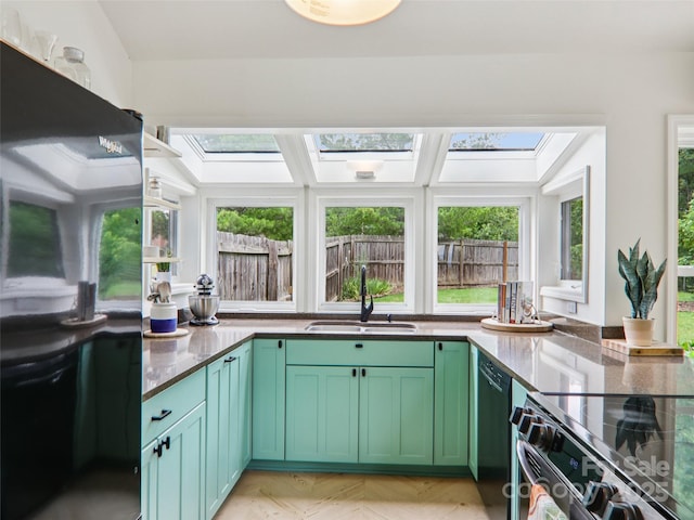 2 Briarwood Dr, Alexander, NC 28701 - kitchen with a skylight, black appliances, and green cabinets