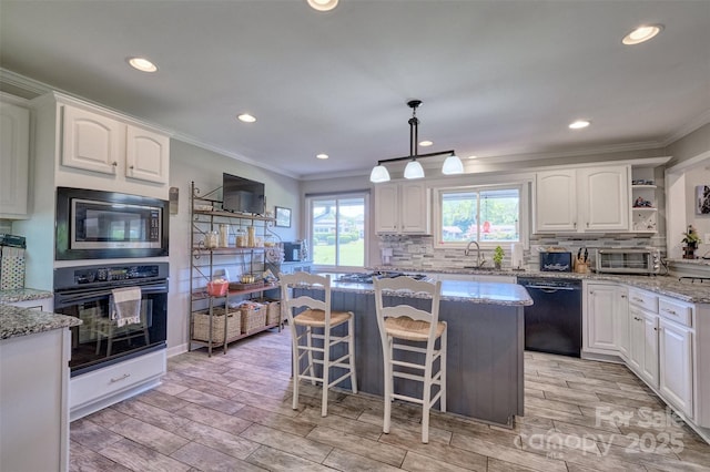 17 Heritage Dr, Lake Wylie, SC 29710 - kitchen with black appliances, ornamental molding, white cabinetry, light stone countertops, and recessed lighting
