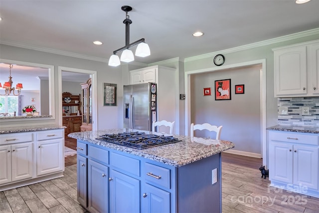 17 Heritage Dr, Lake Wylie, SC 29710 - kitchen with appliances with stainless steel finishes, light wood-style floors, white cabinetry, pendant lighting, and ornamental molding