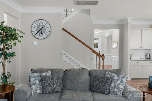 236 Robinwood Ln, Clover, SC 29710 - living room featuring stairway, crown molding, light wood finished floors, and wet bar