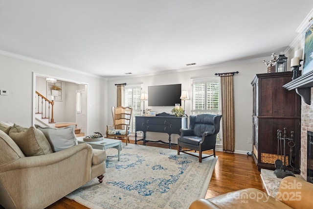 2838 Candleberry Ct, Charlotte, NC 28210 - living room featuring stairs, a fireplace with raised hearth, ornamental molding, and wood finished floors