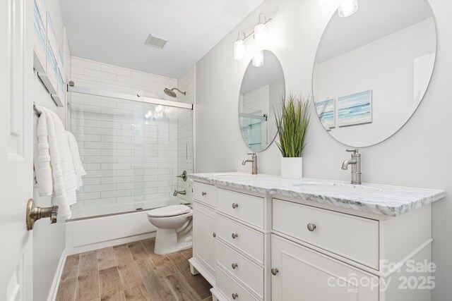 2838 Candleberry Ct, Charlotte, NC 28210 - full bathroom with double vanity, bath / shower combo with glass door, and wood finished floors