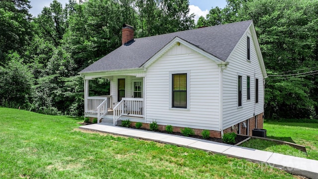 2704 Kool Park Rd NE, Hickory, NC 28601 - view of front of property with a porch, a shingled roof, a front yard, and a chimney