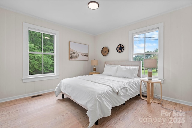 2704 Kool Park Rd NE, Hickory, NC 28601 - bedroom with crown molding, wood finished floors, and a decorative wall