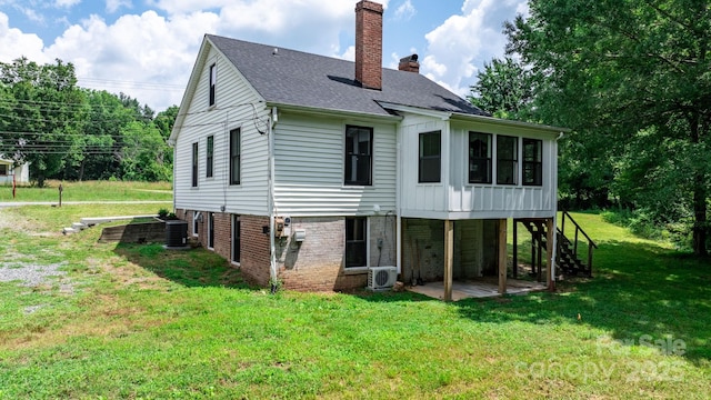 2704 Kool Park Rd NE, Hickory, NC 28601 - rear view of property featuring a chimney, a lawn, a sunroom, and stairway