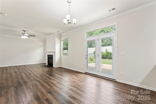 15213 Red Canoe Way, Charlotte, NC 28278 - unfurnished living room with plenty of natural light, dark wood finished floors, crown molding, and a chandelier