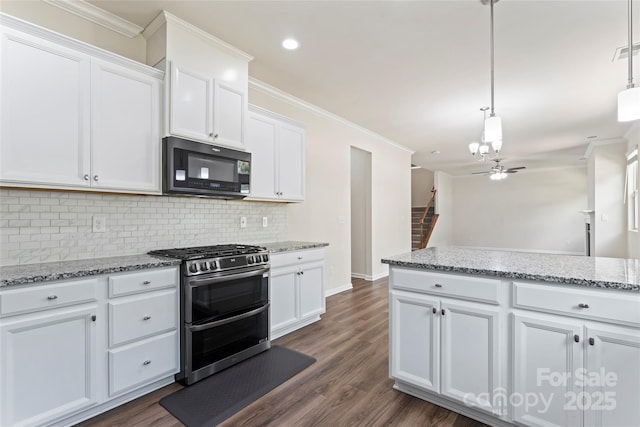 15213 Red Canoe Way, Charlotte, NC 28278 - kitchen with black microwave, range with two ovens, a chandelier, decorative backsplash, and white cabinets