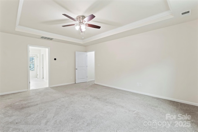15213 Red Canoe Way, Charlotte, NC 28278 - empty room featuring a raised ceiling, crown molding, a ceiling fan, and carpet