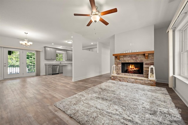 321 Benjamins Way Unit 48, Hendersonville, NC 28792 - unfurnished living room featuring a fireplace, a chandelier, ceiling fan, and wood finished floors
