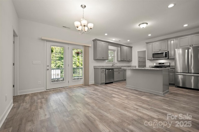 321 Benjamins Way Unit 48, Hendersonville, NC 28792 - kitchen featuring appliances with stainless steel finishes, gray cabinetry, light wood-style floors, a chandelier, and recessed lighting