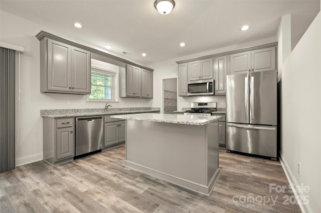 321 Benjamins Way Unit 48, Hendersonville, NC 28792 - kitchen featuring appliances with stainless steel finishes, gray cabinetry, a center island, light wood-style floors, and recessed lighting