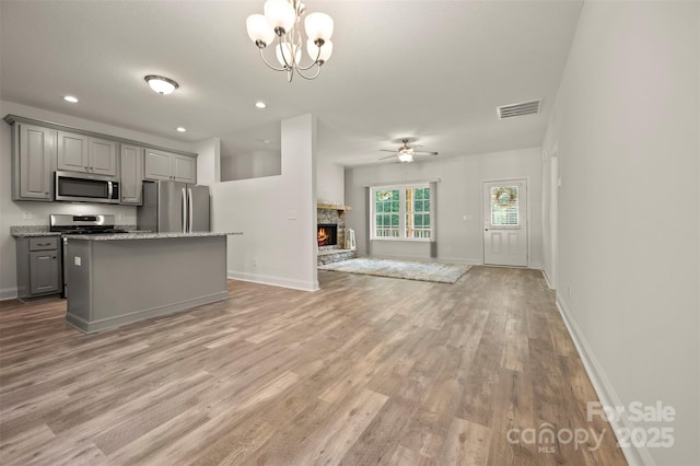 321 Benjamins Way Unit 48, Hendersonville, NC 28792 - kitchen with appliances with stainless steel finishes, gray cabinets, open floor plan, ceiling fan, and light wood finished floors