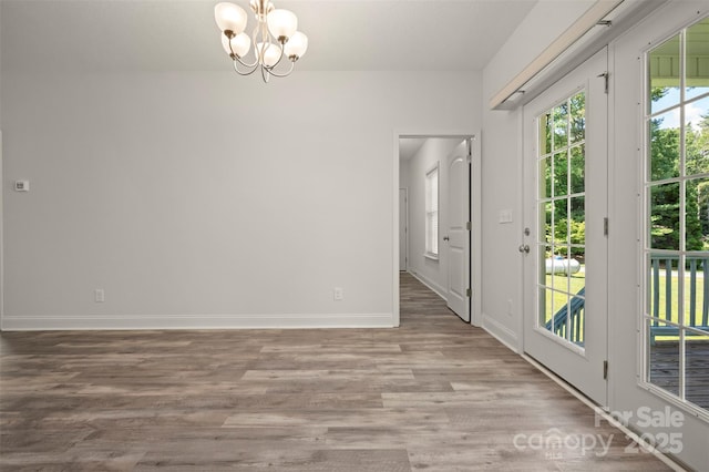 321 Benjamins Way Unit 48, Hendersonville, NC 28792 - empty room featuring a chandelier and wood finished floors
