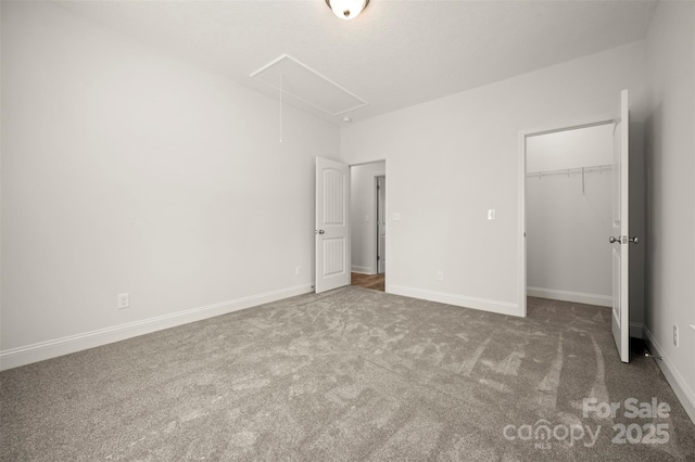 321 Benjamins Way Unit 48, Hendersonville, NC 28792 - unfurnished bedroom with attic access, carpet floors, a closet, and a walk in closet