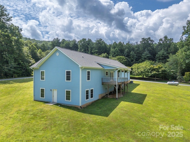 321 Benjamins Way Unit 48, Hendersonville, NC 28792 - rear view of house featuring a yard, a forest view, and a wooden deck