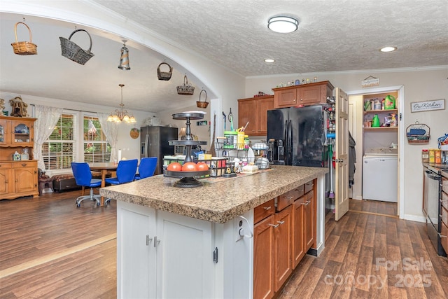 824 Brevard Place Rd, Iron Station, NC 28080 - kitchen featuring washer / clothes dryer, stainless steel fridge, dark wood-style flooring, a kitchen island, and a textured ceiling