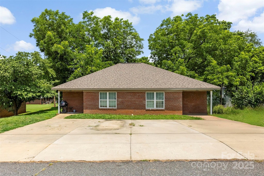 200 Lackey St Unit 1-2, Kings Mountain, NC 28086 - view of front of property featuring a front lawn, roof with shingles, and brick siding