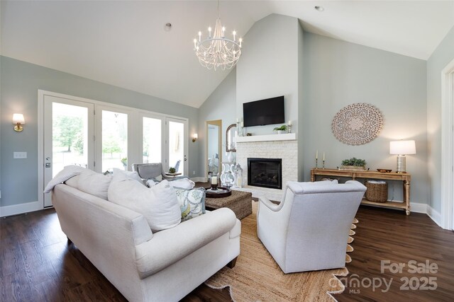 416 Yorkfield Dr, Shelby, NC 28150 - living area with high vaulted ceiling, a fireplace, a chandelier, and wood finished floors