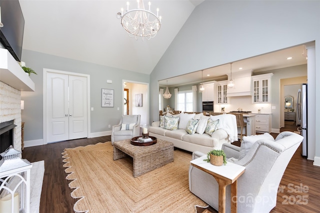 416 Yorkfield Dr, Shelby, NC 28150 - living room featuring a chandelier, high vaulted ceiling, dark wood-style floors, a fireplace, and recessed lighting