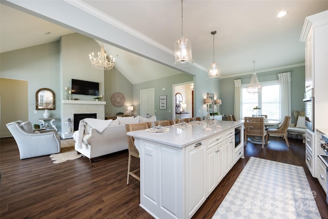 416 Yorkfield Dr, Shelby, NC 28150 - kitchen with a chandelier, dark wood finished floors, white cabinets, crown molding, and high vaulted ceiling