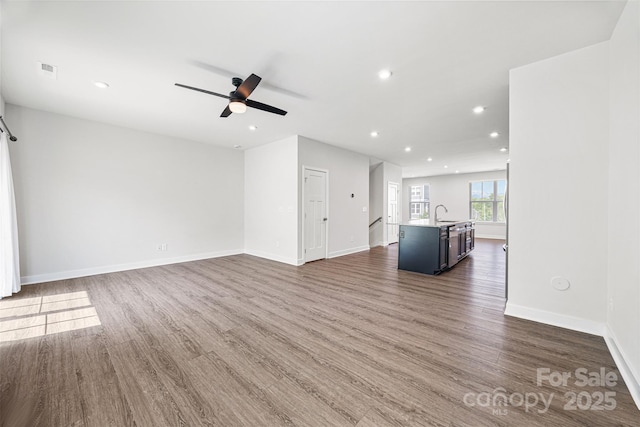 2040 Dornoch Rd, Tega Cay, SC 29708 - unfurnished living room featuring dark wood-style floors, ceiling fan, and recessed lighting