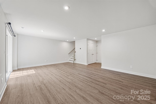 2040 Dornoch Rd, Tega Cay, SC 29708 - empty room featuring stairway, wood finished floors, and recessed lighting