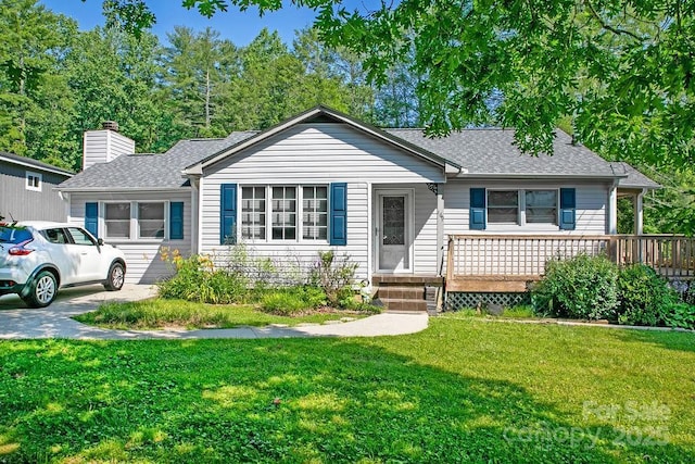 169 Montview Cir, Brevard, NC 28712 - view of front of house featuring a shingled roof, a front lawn, and a chimney