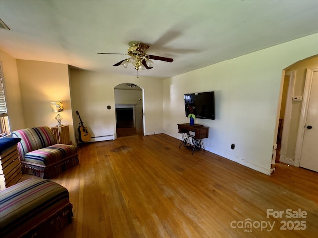 169 Montview Cir, Brevard, NC 28712 - living room with arched walkways, a ceiling fan, wood finished floors, and a baseboard heating unit