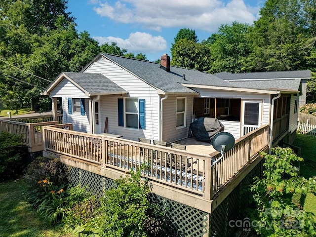 169 Montview Cir, Brevard, NC 28712 - rear view of house featuring a chimney, roof with shingles, a wooden deck, and a sunroom