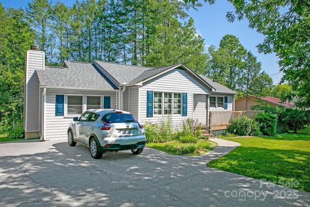 169 Montview Cir, Brevard, NC 28712 - ranch-style home with a chimney, a front yard, roof with shingles, and driveway