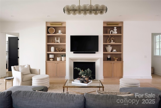 1401 Heather Ln, Charlotte, NC 28209 - living room featuring light wood-style floors, a fireplace, and built in features