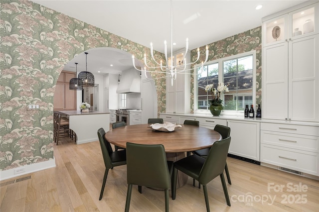 1401 Heather Ln, Charlotte, NC 28209 - dining room with wallpapered walls, a chandelier, light wood-type flooring, and recessed lighting
