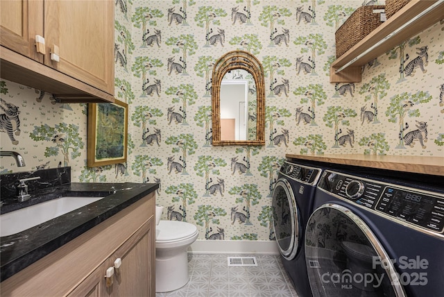1401 Heather Ln, Charlotte, NC 28209 - bathroom with wallpapered walls, washing machine and dryer, and vanity