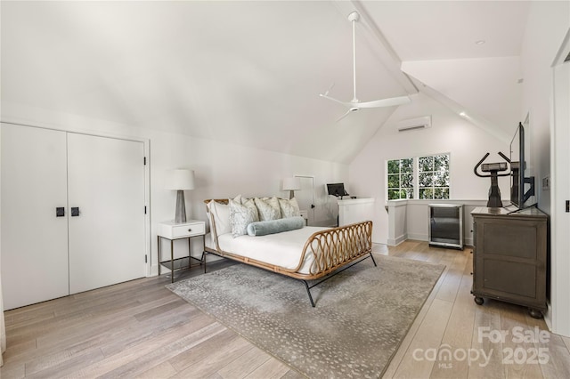 1401 Heather Ln, Charlotte, NC 28209 - bedroom with light wood finished floors, a wall mounted air conditioner, wine cooler, fridge, and ceiling fan