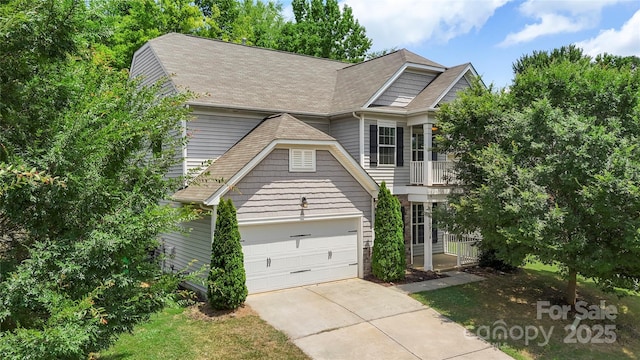 10806 Cove Point Dr, Charlotte, NC 28278 - view of front of home with concrete driveway, a shingled roof, and an attached garage