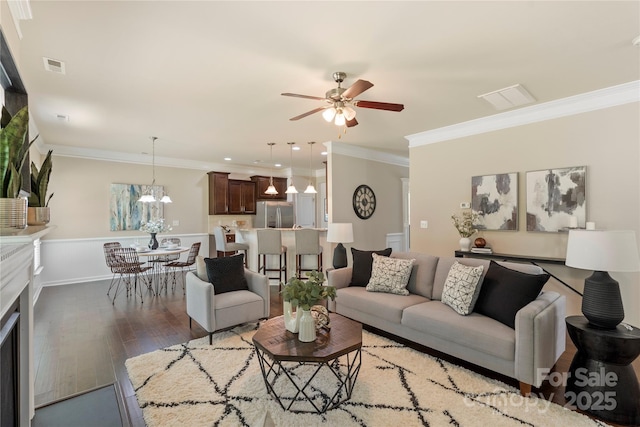 10806 Cove Point Dr, Charlotte, NC 28278 - living room with a ceiling fan, wood finished floors, ornamental molding, a wainscoted wall, and recessed lighting