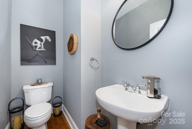 4937 S Hill View Dr, Charlotte, NC 28210 - half bathroom featuring a sink and wood finished floors